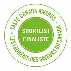 Award Seal for the Taste Canada Awards is circular, the centre text is white, bold and all caps set in a green circle, the text reads Shortlist / Finaliste. More text surrounds the circle which is bold, green and all caps laid into a white background, the text reads Taste Canada Awards / Les Laureats des saveurs du Canada